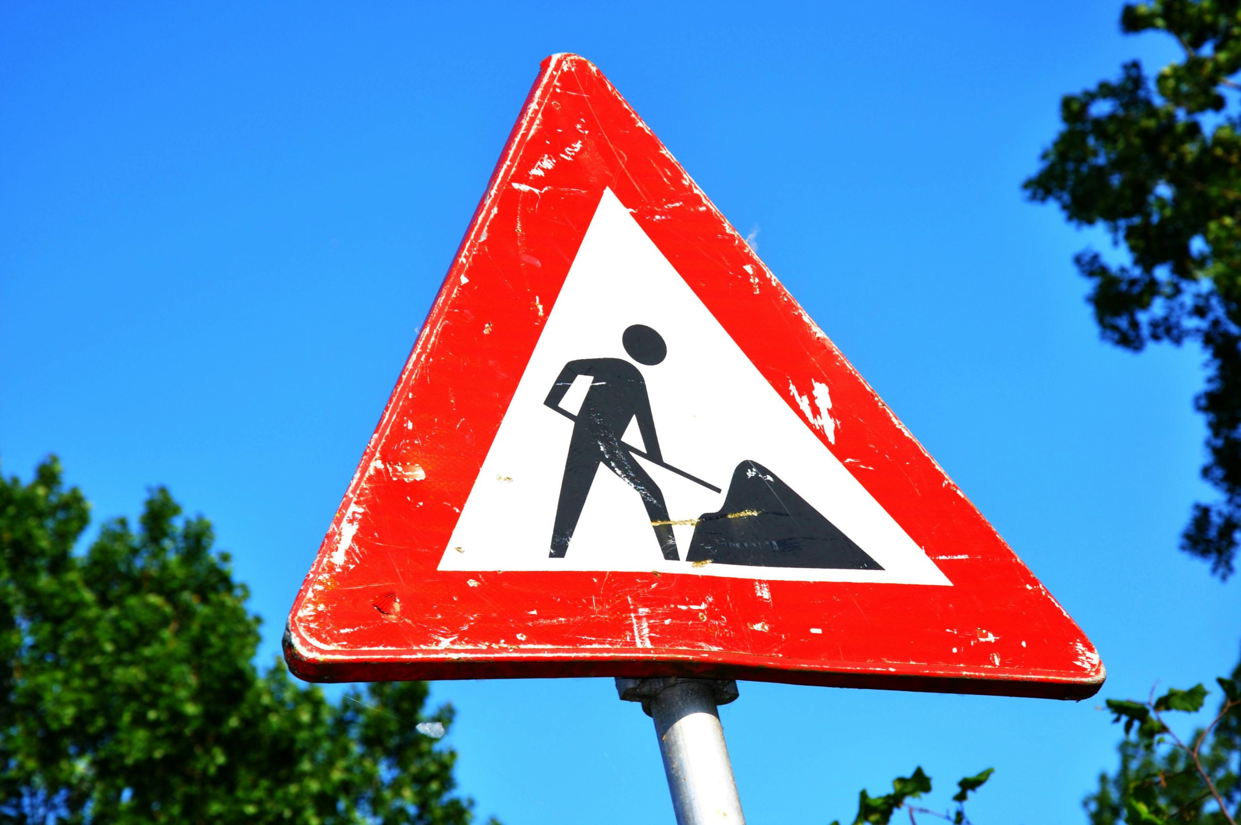 Close-up Photography of Red and White Road Signage